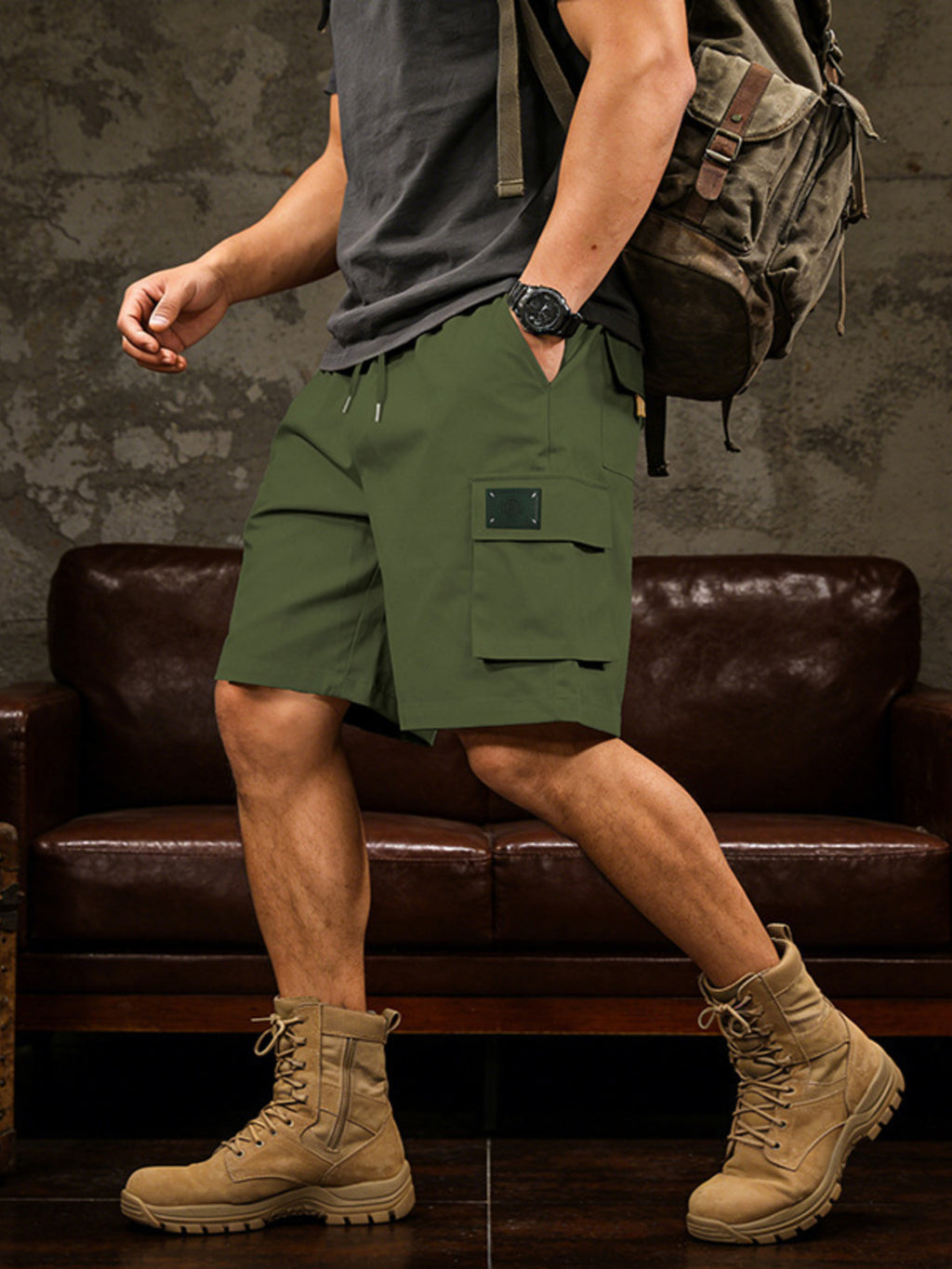 Detailed close up of the spacious side cargo pocket with durable double stitching on CLOTHRA men full size casual shorts. in a color Green