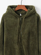 Detailed close up of the deep side hand pockets and ultra-soft woven fleece fabric texture on CLOTHRA unisex outerwear. in a color Army Green