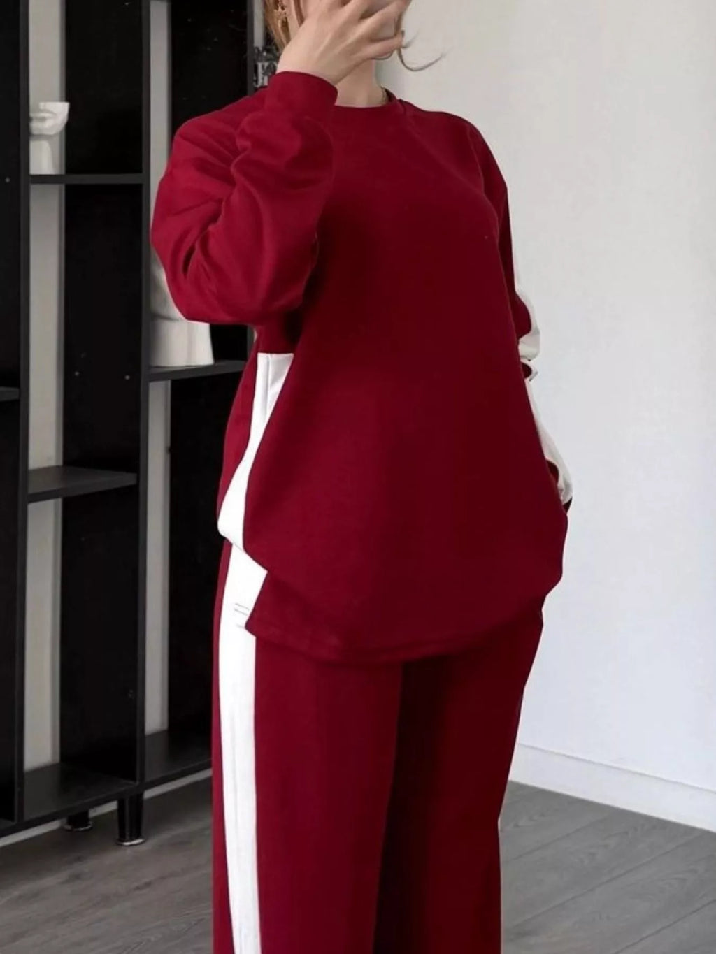 Close up of the high contrast color paneling and ribbed round neck collar on CLOTHRA plus size streetwear top. in a color Burgundy