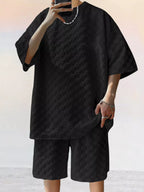 CLOTHRA men plus size matching two piece textured t-shirt and shorts set showing a structured boxy fit and premium casual resort style drape. in a color Black