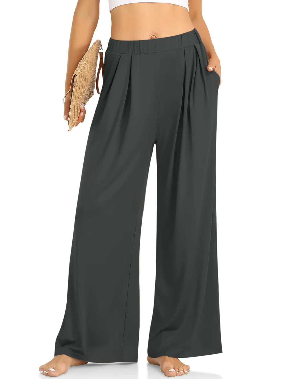 CLOTHRA minimalist elastic waist wide leg pants showing a relaxed baggy fluid drape in an authentic urban street look. in a color Dark Grey