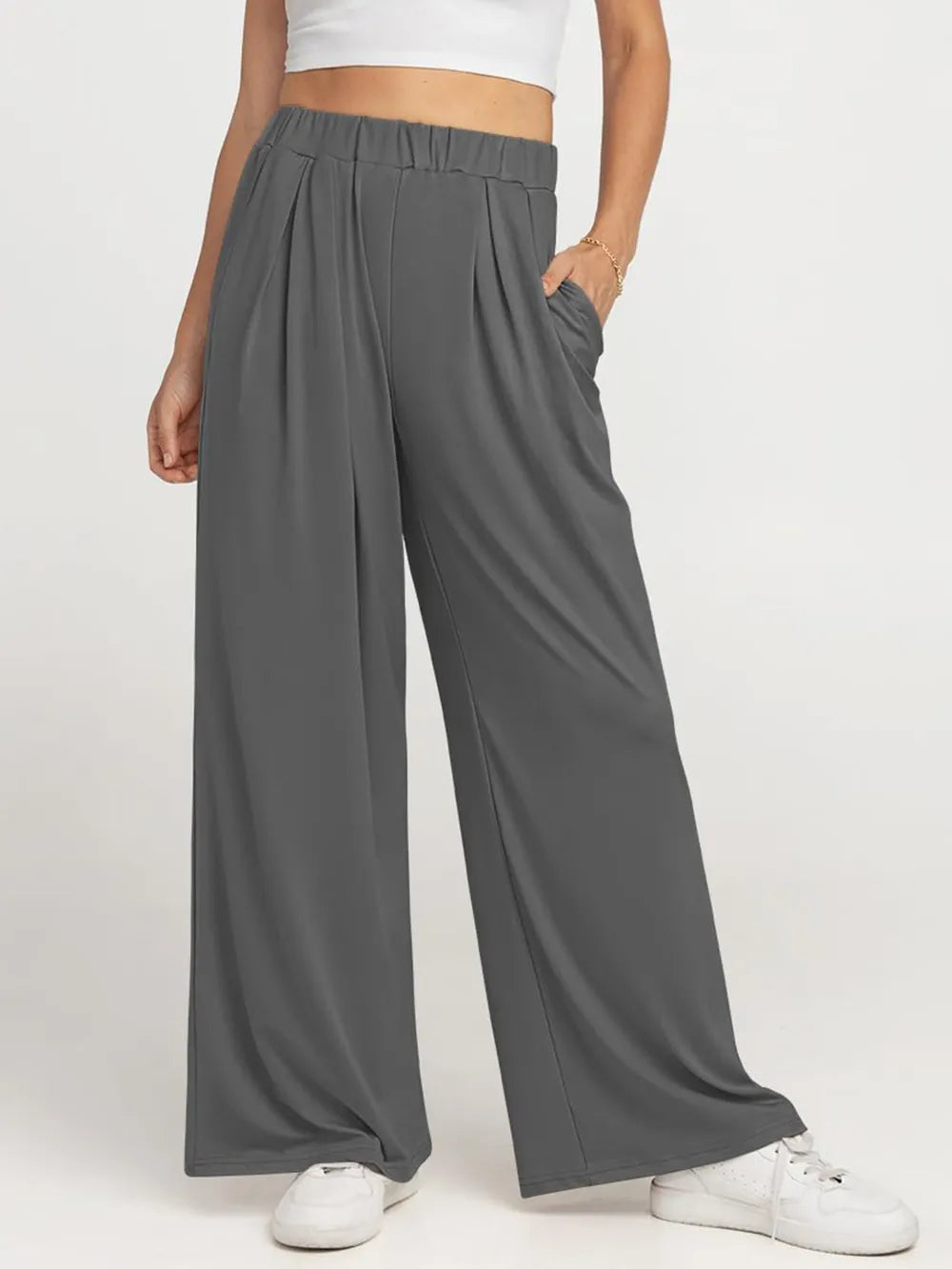 CLOTHRA minimalist elastic waist wide leg pants showing a relaxed baggy fluid drape in an authentic urban street look. in a color Grey