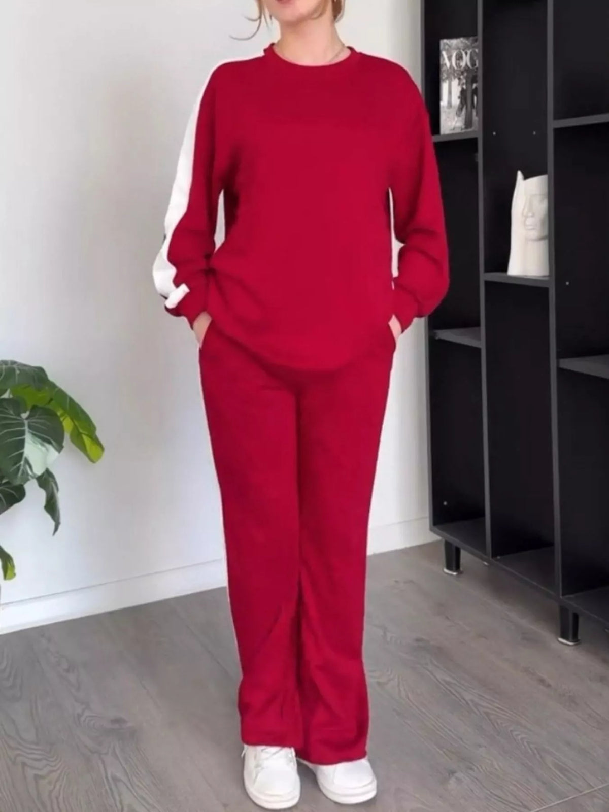 Close up shot of the secure stitching, premium fabric texture, and flexible stretch waistband on CLOTHRA matching pants.  in a color Red