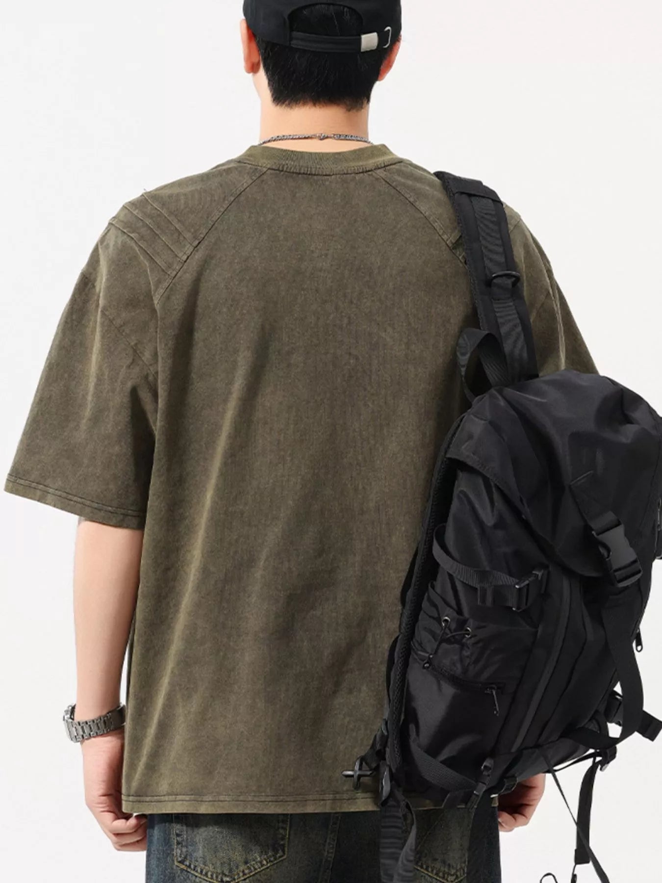 Close up shot of the soft pigment washed cotton spandex fabric showing its slight stretch flexibility on CLOTHRA matching shirt. Back side view