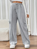 Close up of the adjustable front drawstring tie and premium polycotton fabric weave on CLOTHRA wide leg trousers.