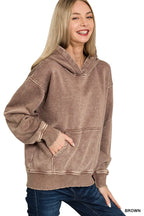 Close up of the spacious front kangaroo pocket and vintage acid wash fabric texture on CLOTHRA fleece hoodie.