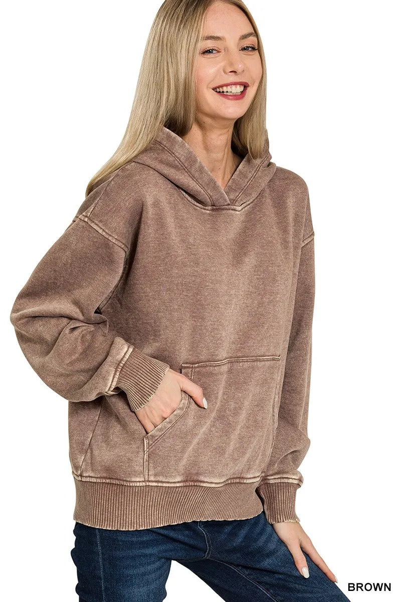 Close up of the spacious front kangaroo pocket and vintage acid wash fabric texture on CLOTHRA fleece hoodie.